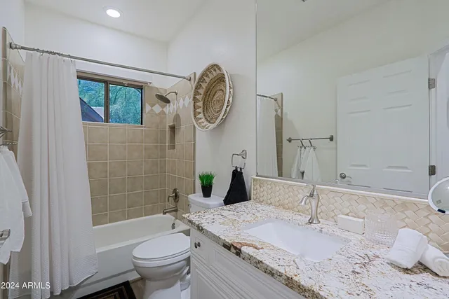 a view of a house with backyard sitting area and swimming pool