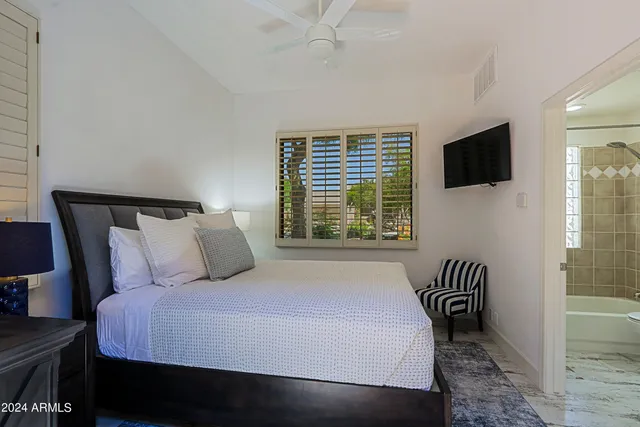 a dining room with lots of furniture and a rug