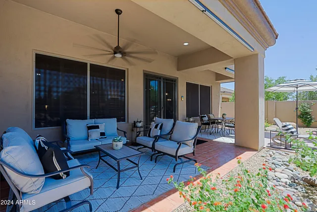 a living room with furniture a rug and a chandelier