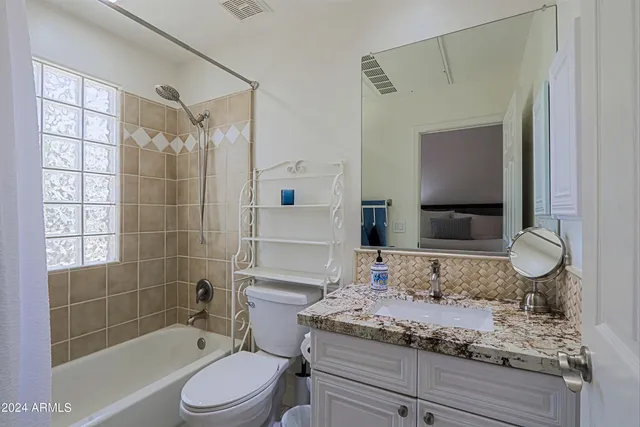 a living room with lots of furniture and a large window