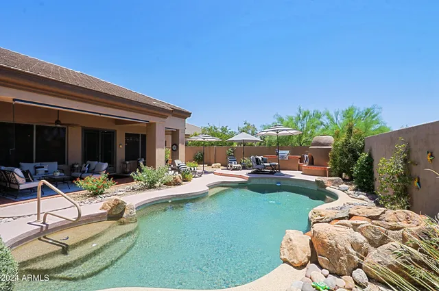 a view of swimming pool with outdoor seating and city view