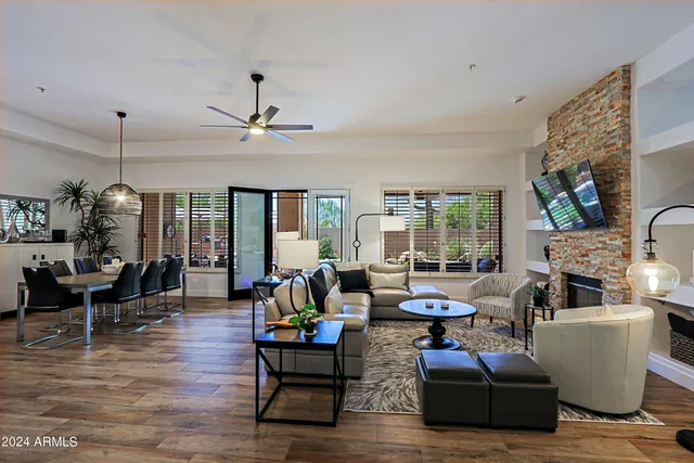 a living room with fireplace furniture and a wooden floor