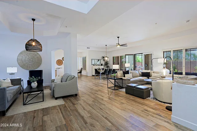 a living room with furniture flat screen tv and wooden floor