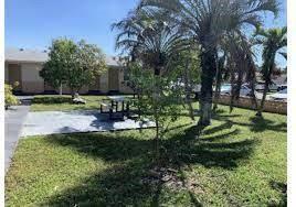 7511 Venetian Street, Unit 8 Miramar, FL 33023 - Photo 15 of 15 a view of a garden with a bench