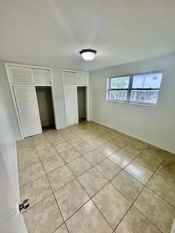 a view of a livingroom with an empty space and a window