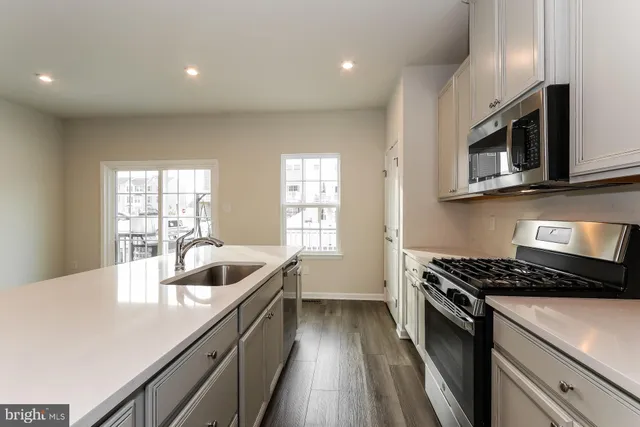 a kitchen with a sink and cabinets