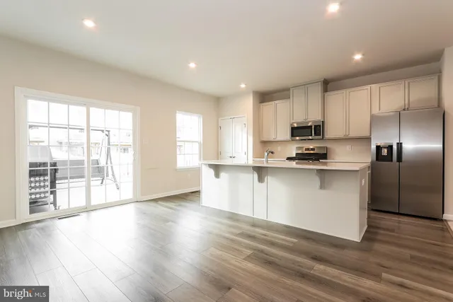 a kitchen with stainless steel appliances a refrigerator sink and microwave