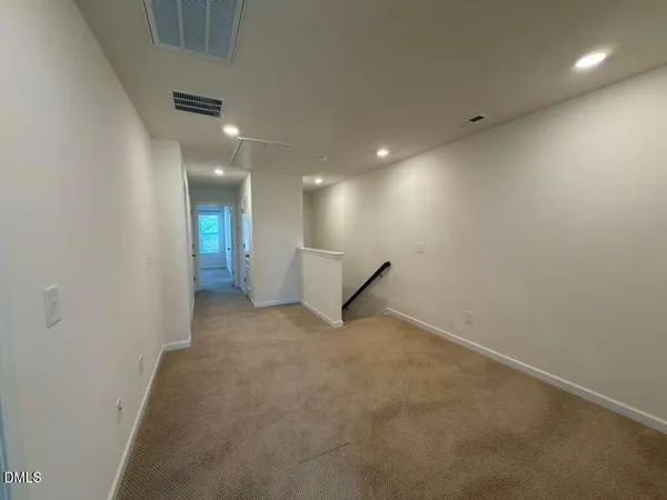 an empty room with a projector and white walls