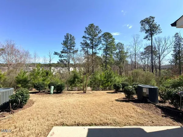 a view of swimming pool with a yard in front of it