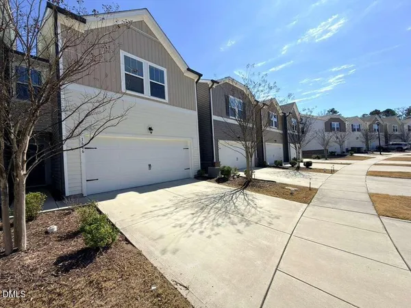 a view of a house with snow on the road