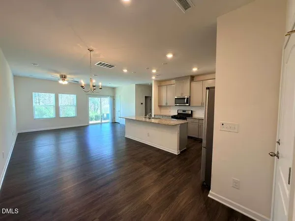 a view of kitchen with cabinets and wooden floor