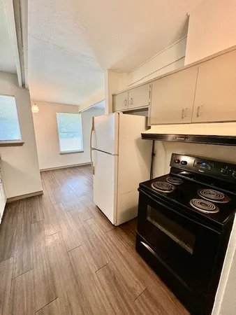 a stove top oven sitting inside of a kitchen