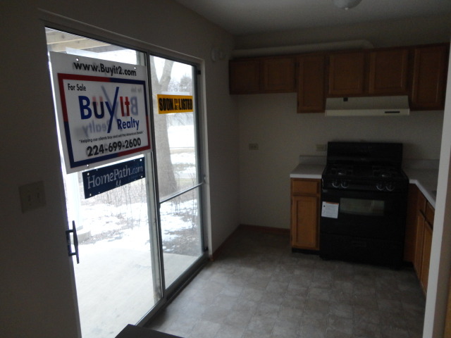 3 North Victoria Lane, Unit B Streamwood, IL 60107 - Photo 11 of 11 a kitchen with a refrigerator and a stove top oven