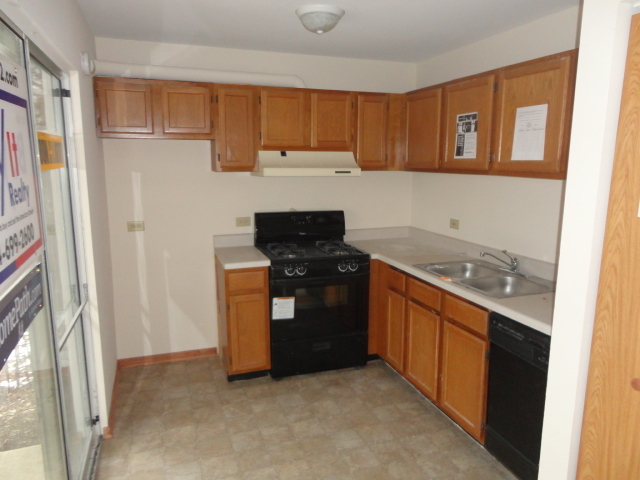 3 North Victoria Lane, Unit B Streamwood, IL 60107 - Photo 5 of 11 a kitchen with a refrigerator and a stove