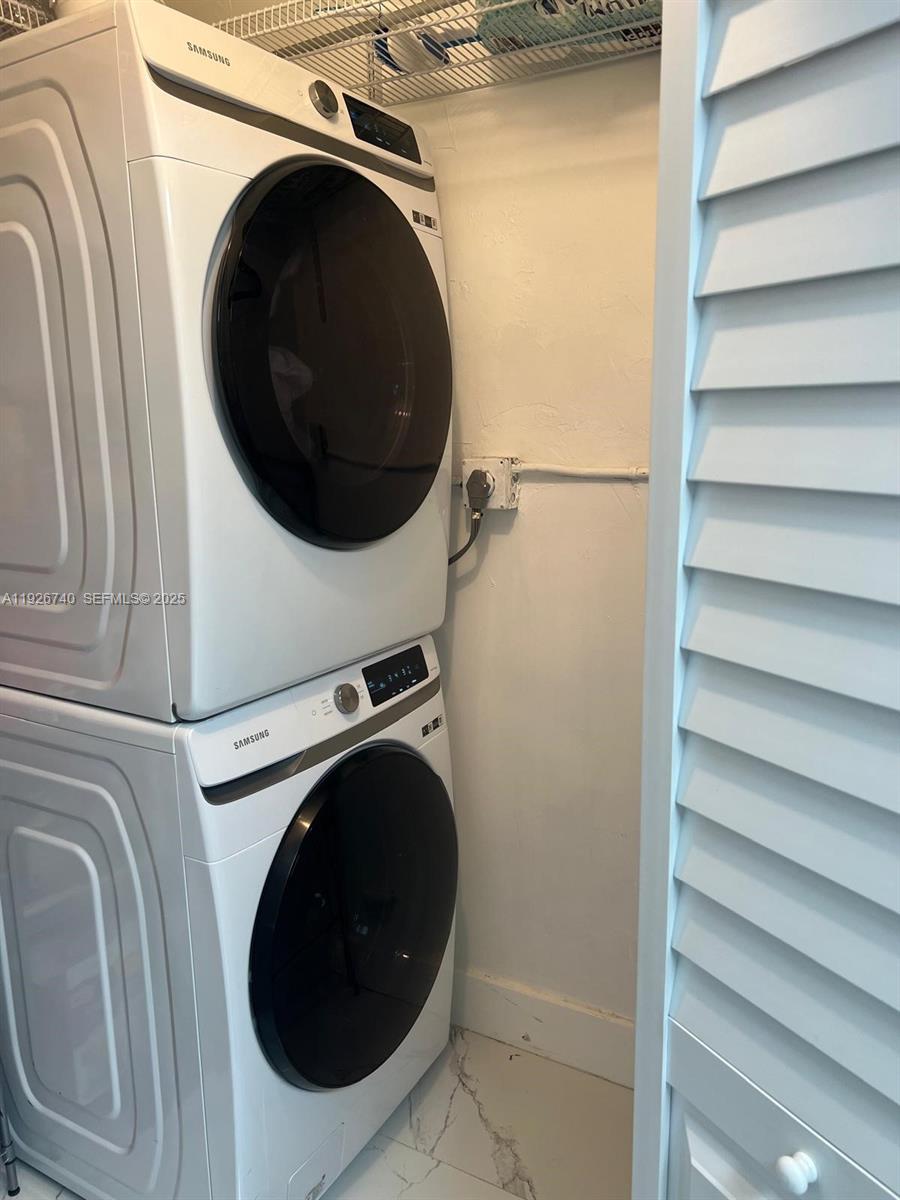 9273 Collins Avenue, Unit 606 Surfside, FL 33154 - Photo 11 of 18 a close up view of a washer and dryer