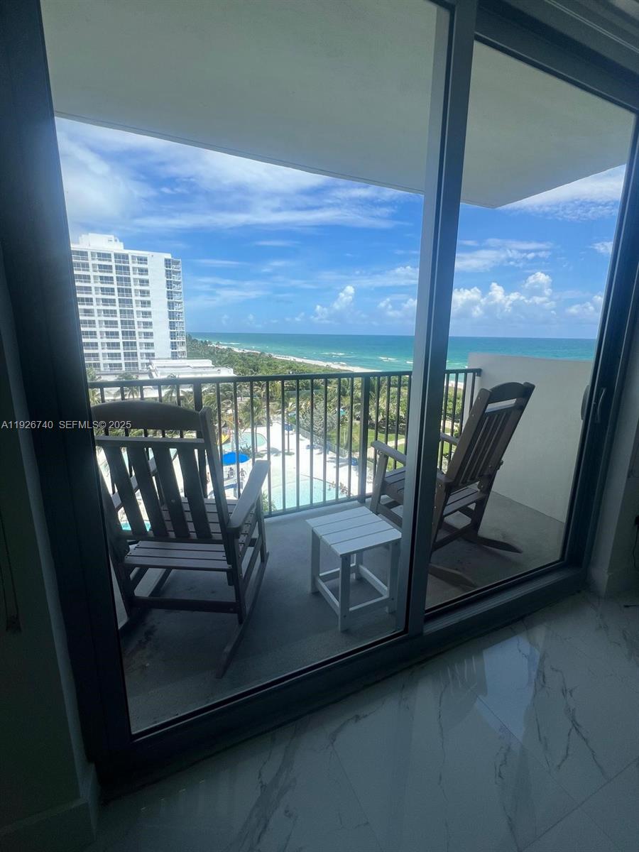 9273 Collins Avenue, Unit 606 Surfside, FL 33154 - Photo 3 of 18 a view of a balcony with chairs