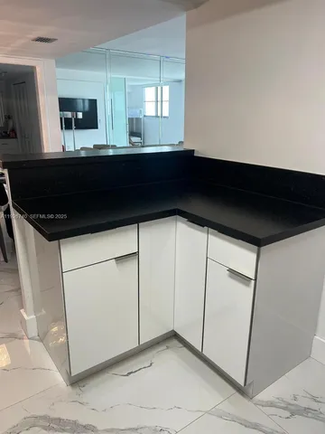 a kitchen with a sink and cabinets