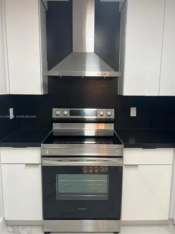 a stove top oven sitting inside of a kitchen