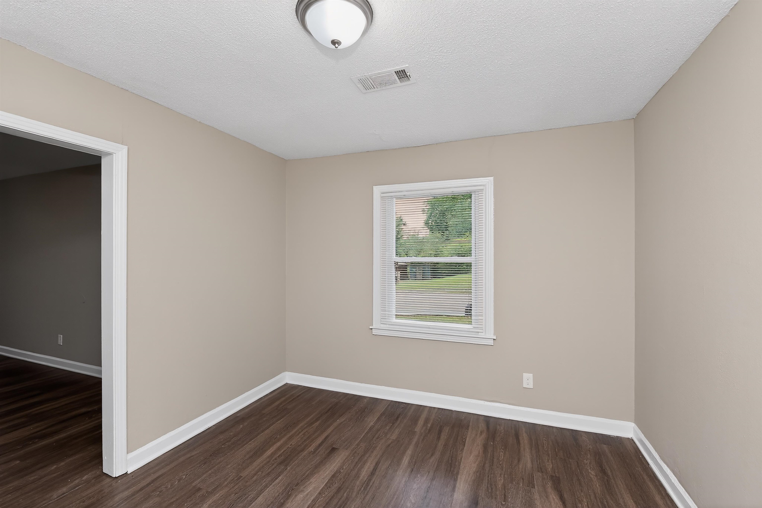 318 East Raines Road Memphis, TN 38109 - Photo 10 of 28 Interior room featuring wood-finish flooring, neutral wall paint, and white trim