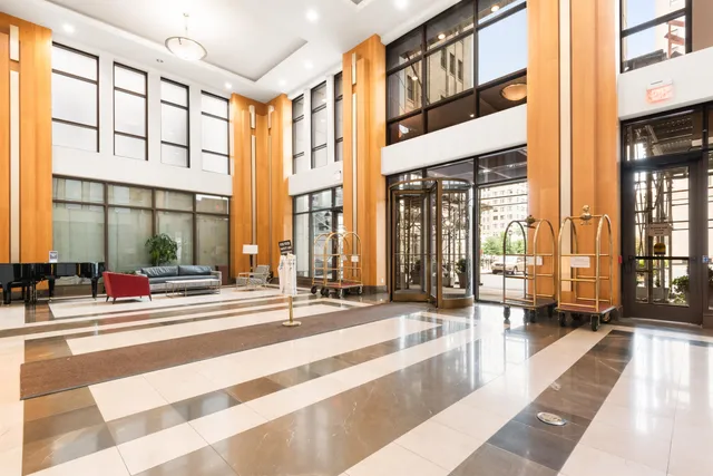 a lobby with furniture and large windows