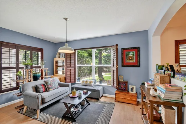 a living room with furniture and a large window