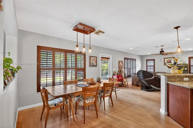 a view of a dining room with furniture window and outside view