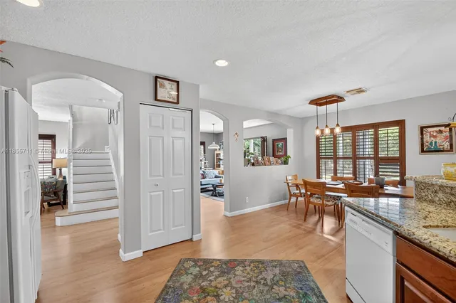 a living room with furniture a flat screen tv and a window