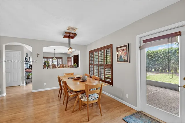 a living room with furniture ceiling fan and a window