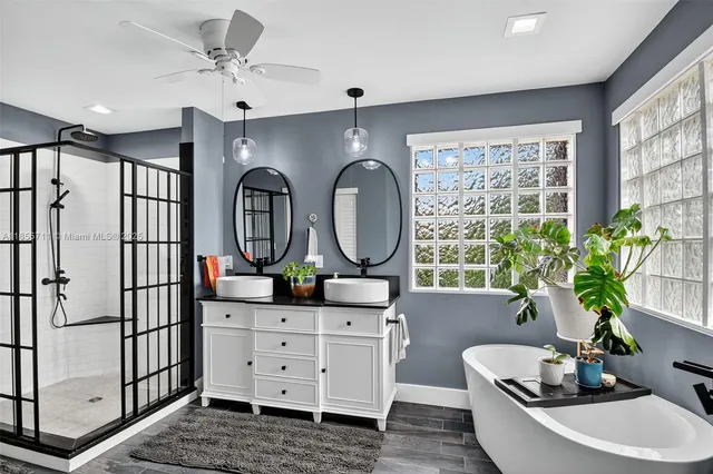 a spacious bathroom with a sink and a mirror