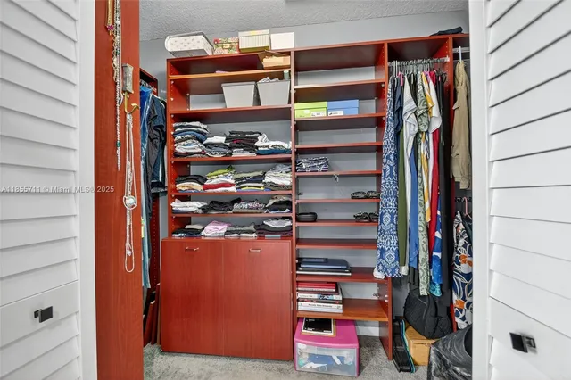 a bedroom with a bed dresser and a window