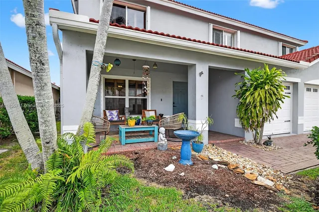 a front view of a house with outdoor seating