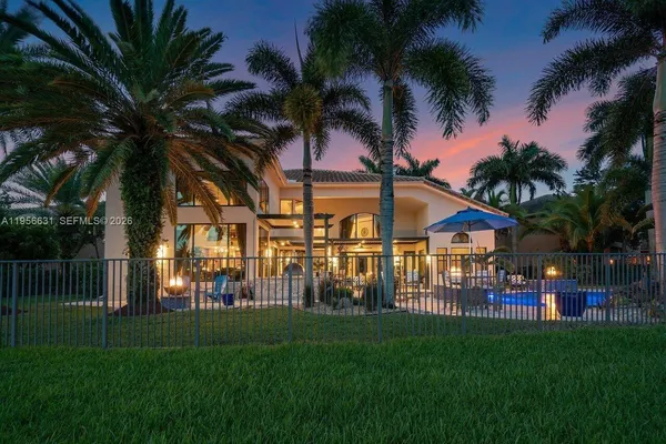 a kitchen with stainless steel appliances granite countertop a sink and wooden cabinets