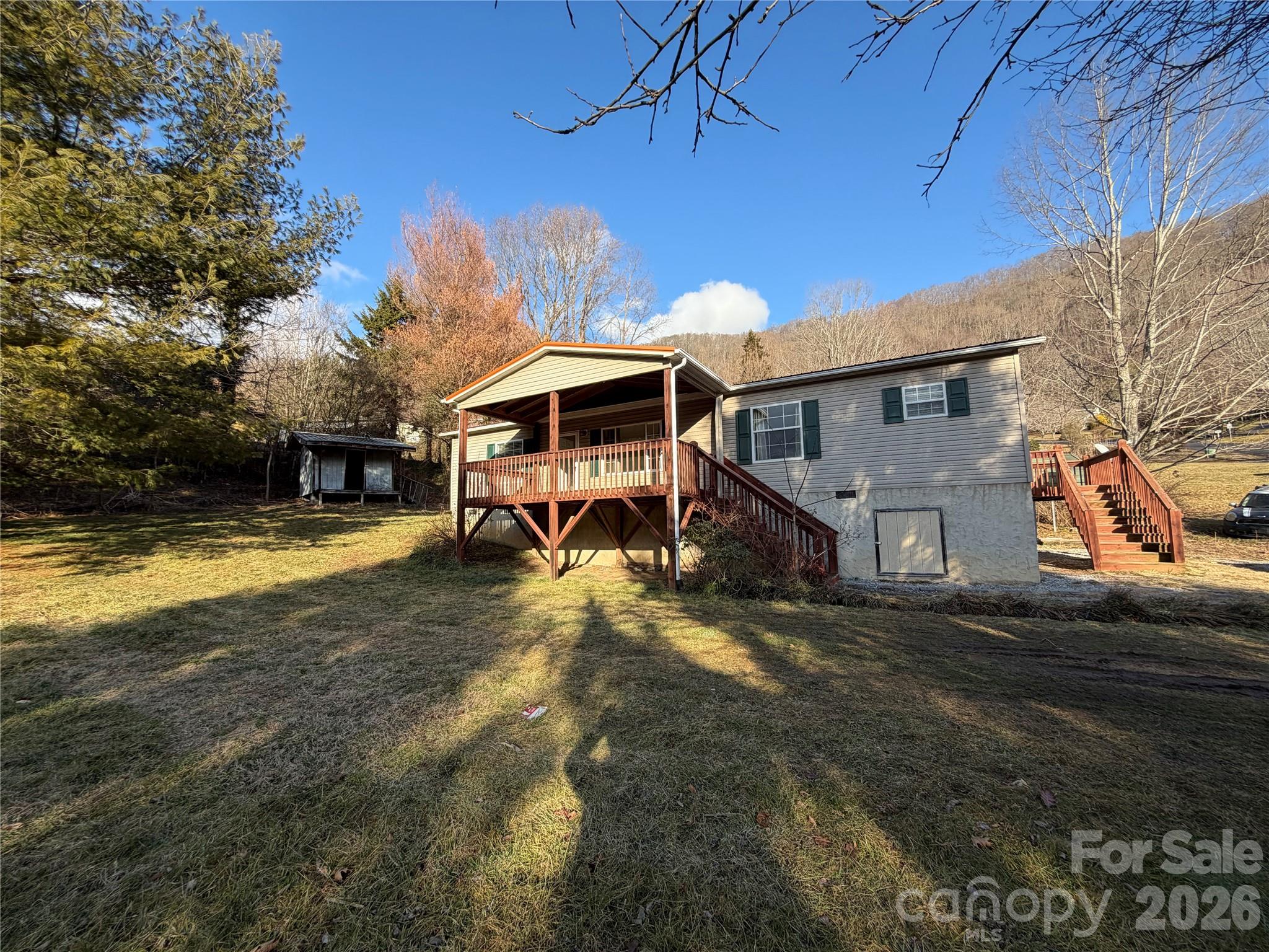 101 Highview Drive Maggie Valley, NC 28751 - Photo 1 of 29 a view of a house with pool and a yard