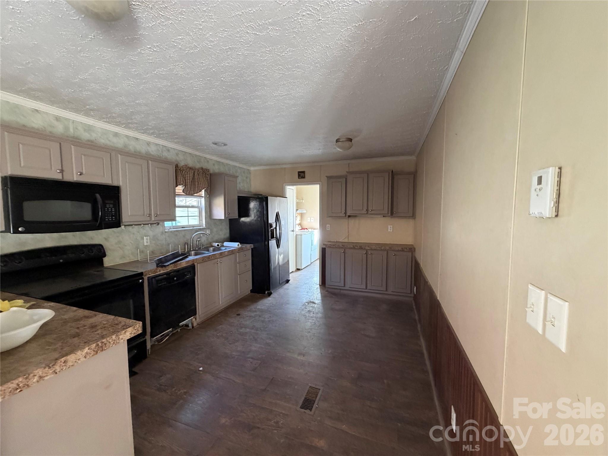 101 Highview Drive Maggie Valley, NC 28751 - Photo 3 of 29 a large kitchen with a stove a microwave and a refrigerator