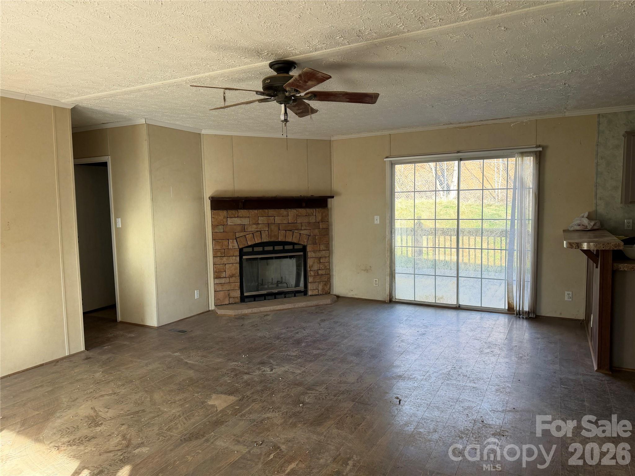 101 Highview Drive Maggie Valley, NC 28751 - Photo 6 of 29 a view of empty room with a fireplace and fan