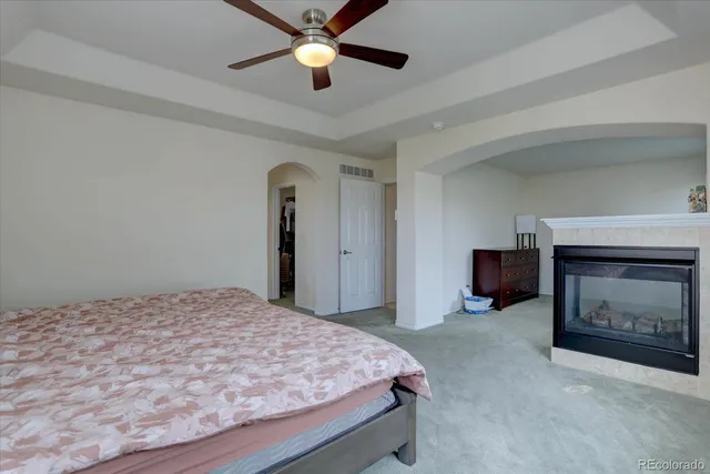a bedroom with a bed and a fireplace