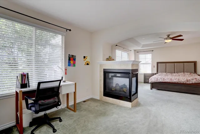 a bedroom with furniture and a fireplace