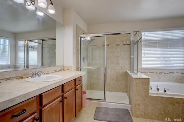 a bathroom with a shower sink vanity and mirror