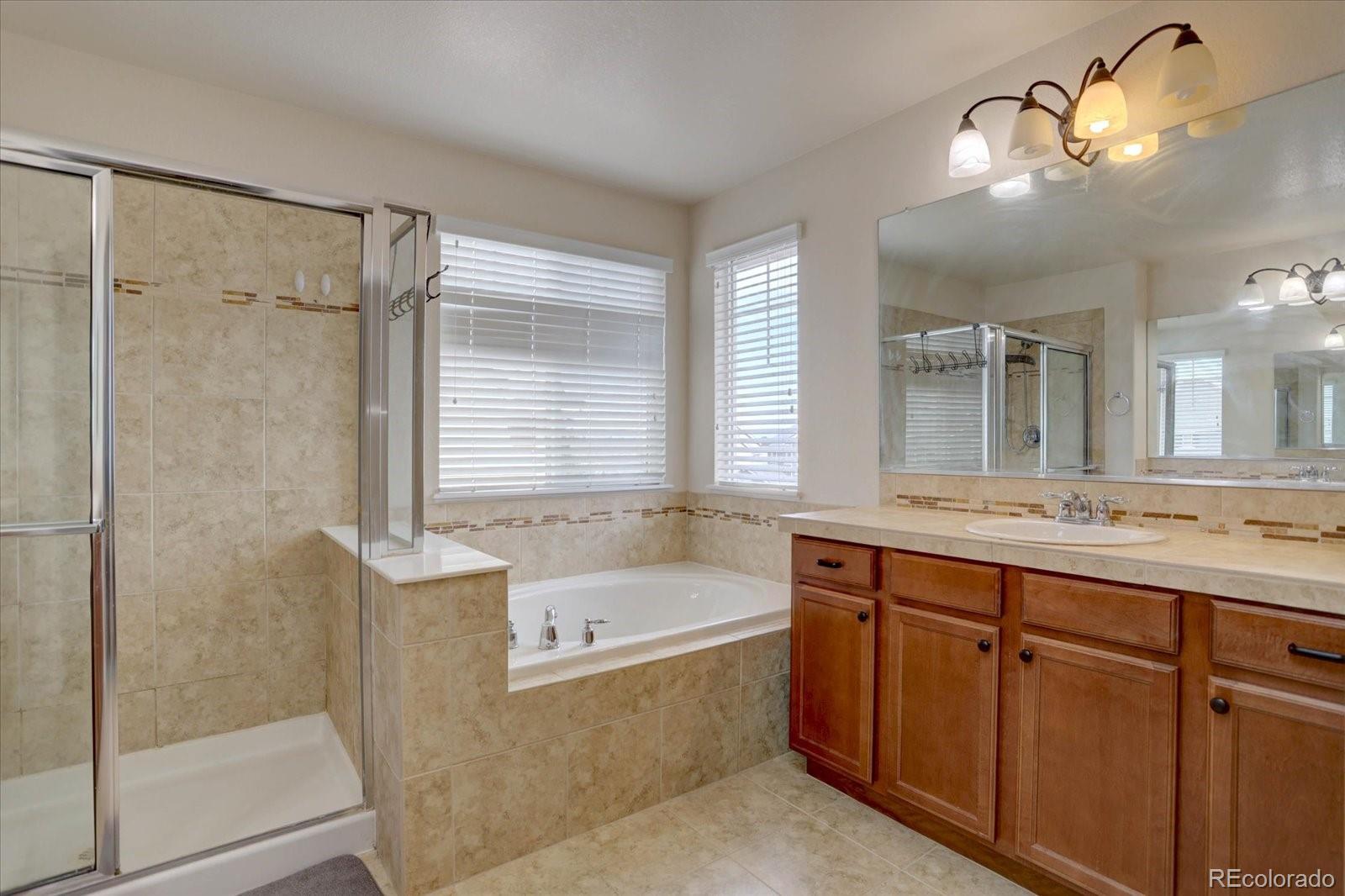 5300 Fullerton Lane Highlands Ranch, CO 80130 - Photo 18 of 31 a bathroom with a tub sink and mirror