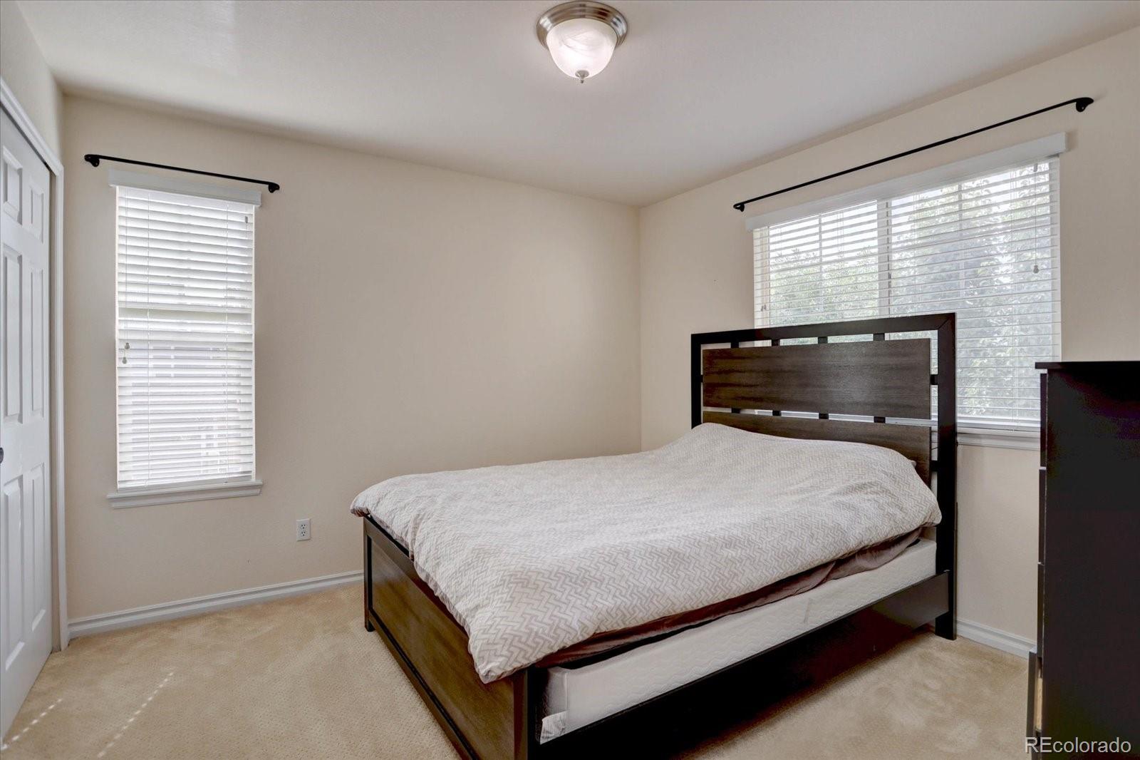 5300 Fullerton Lane Highlands Ranch, CO 80130 - Photo 19 of 31 a bedroom with a bed and window