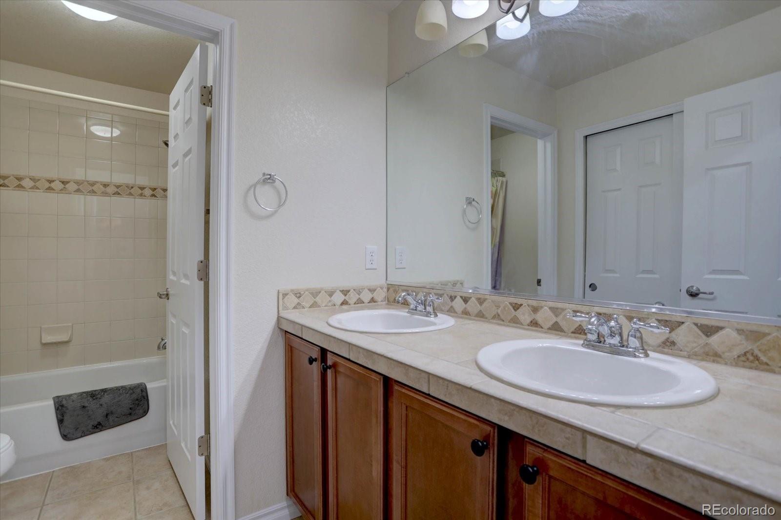 5300 Fullerton Lane Highlands Ranch, CO 80130 - Photo 21 of 31 a bathroom with a sink and a mirror