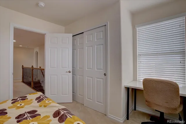 a bedroom with a bed and a chair