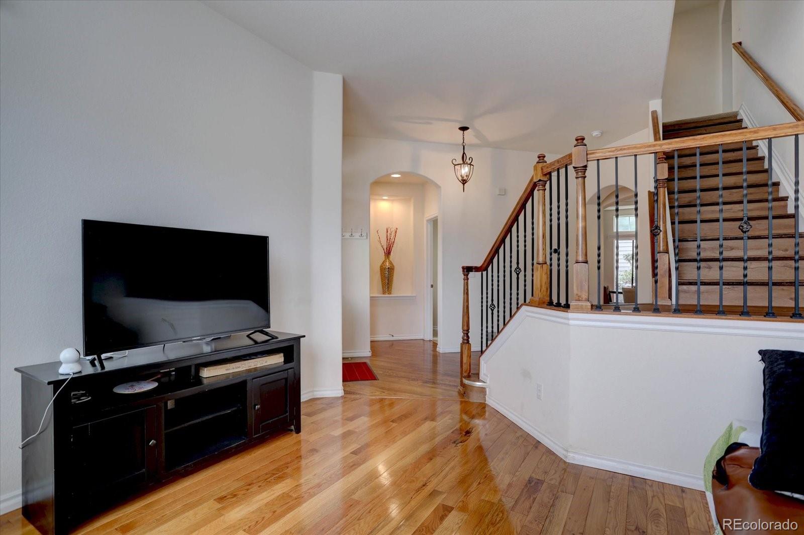 5300 Fullerton Lane Highlands Ranch, CO 80130 - Photo 4 of 31 a living room with furniture and a flat screen tv
