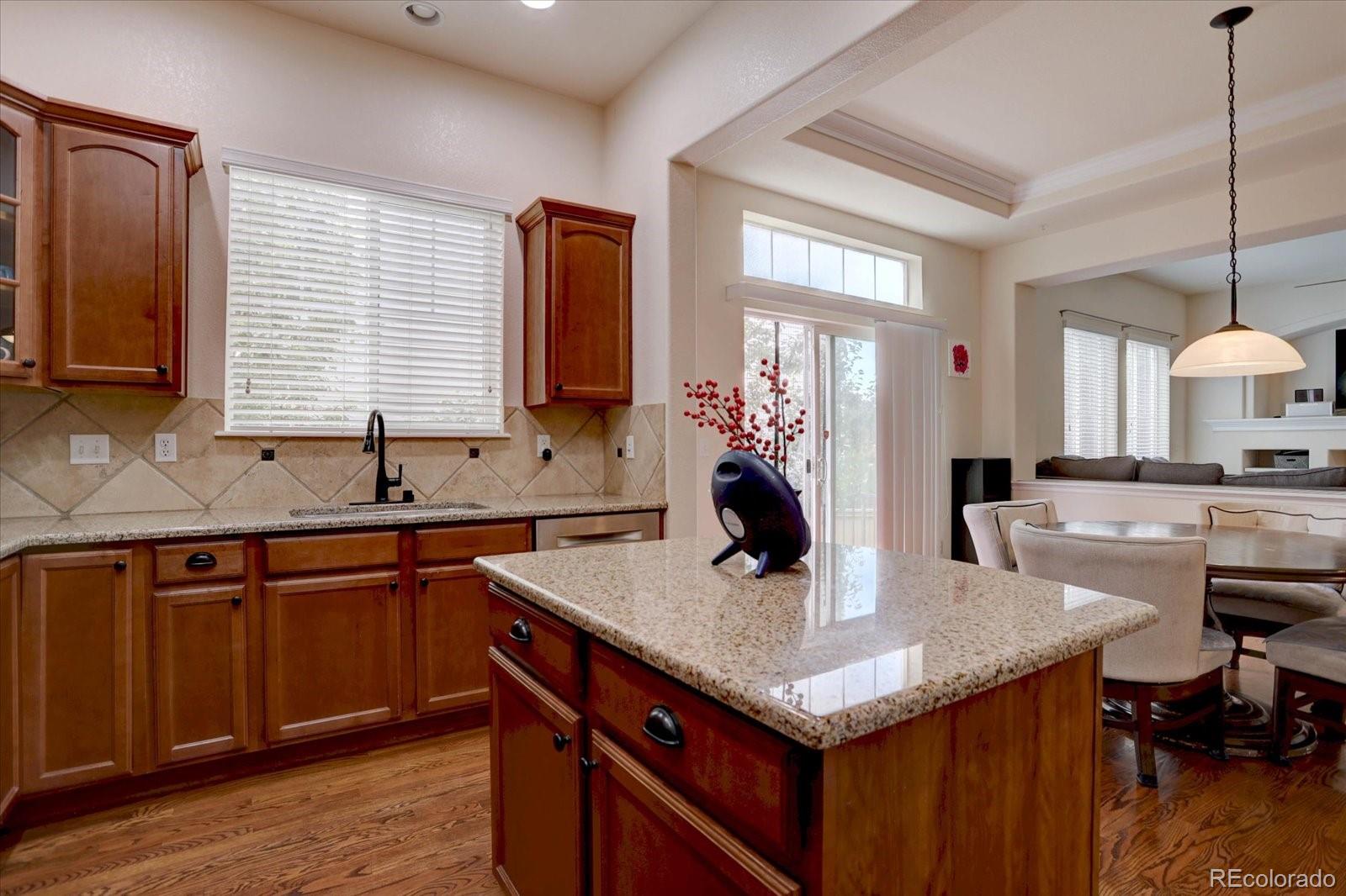 5300 Fullerton Lane Highlands Ranch, CO 80130 - Photo 8 of 31 a kitchen with granite countertop a sink cabinets and wooden floor