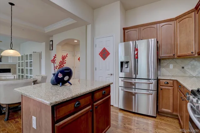 a kitchen with stainless steel appliances granite countertop a refrigerator and a sink