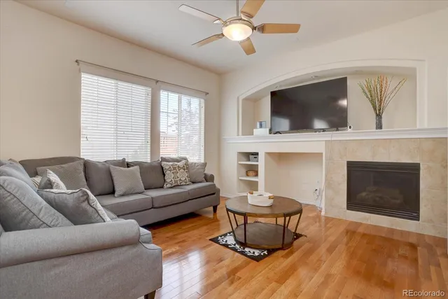 a living room with furniture a fireplace and a flat screen tv