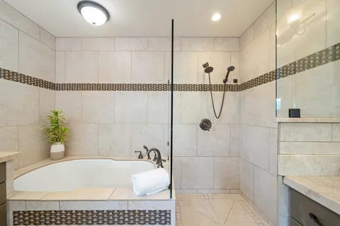 a bathroom with a tub and shower