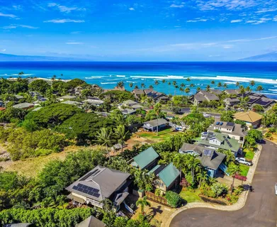 an aerial view of a house with a ocean view