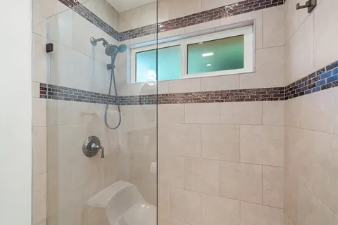 a bathroom with a shower and a mirror