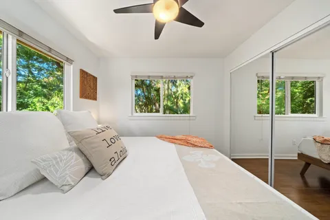 a bedroom with a bed and a large window